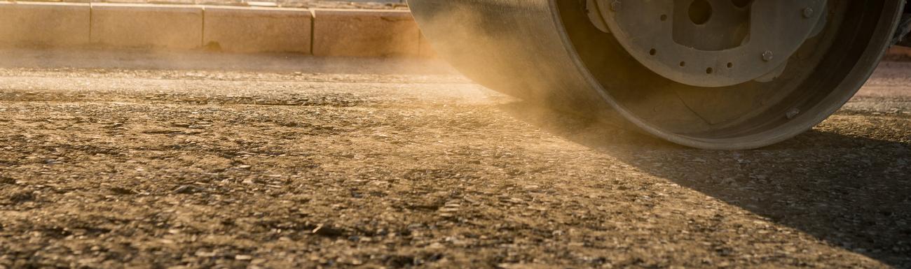 Potholes, repairs and maintenance of tarmac road or driveway. Tarmac roller.